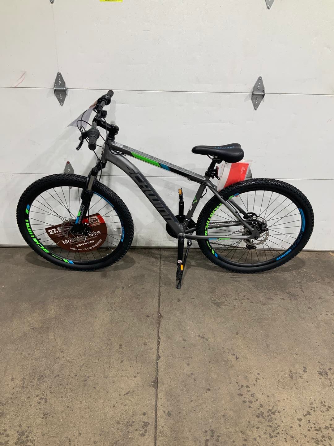 A bicycle is parked in front of a garage door.