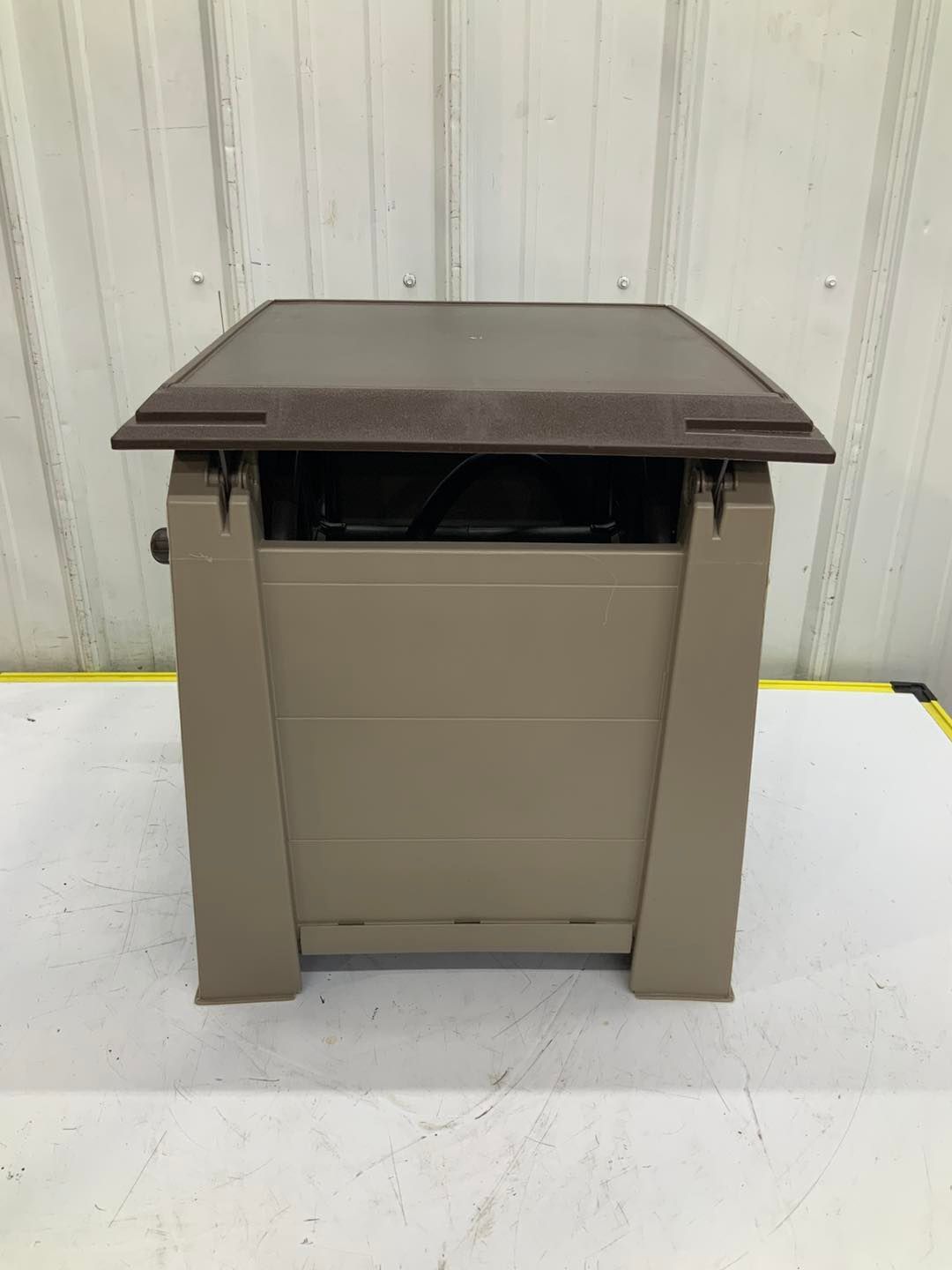 A small brown box is sitting on top of a white table.