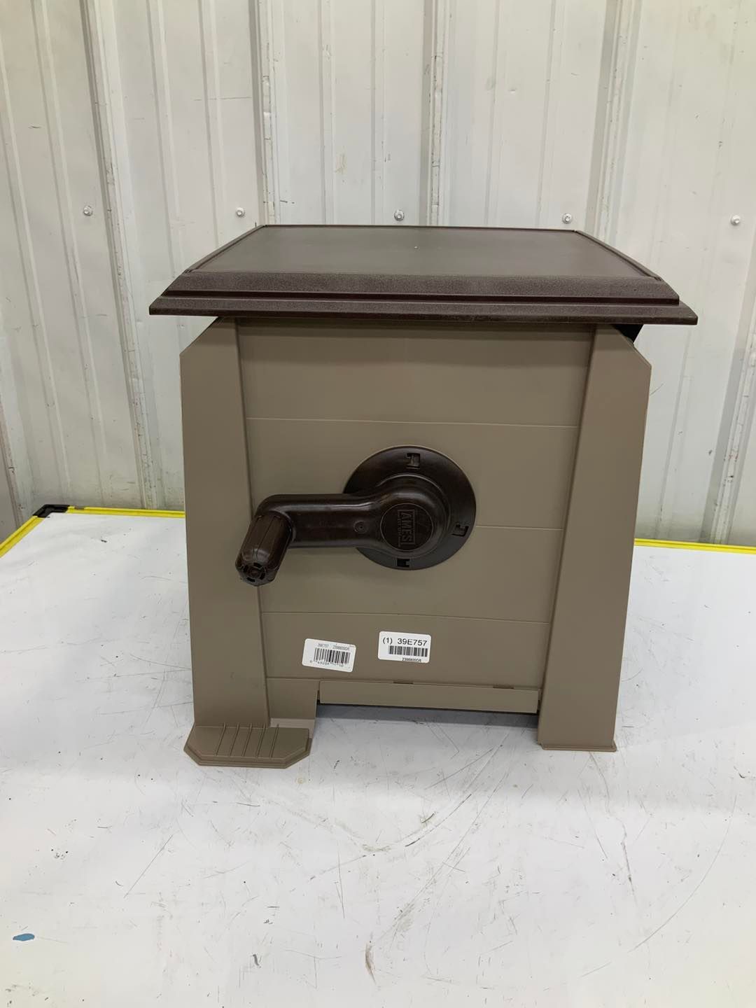 A small wooden box with a handle on top of it is sitting on a table.