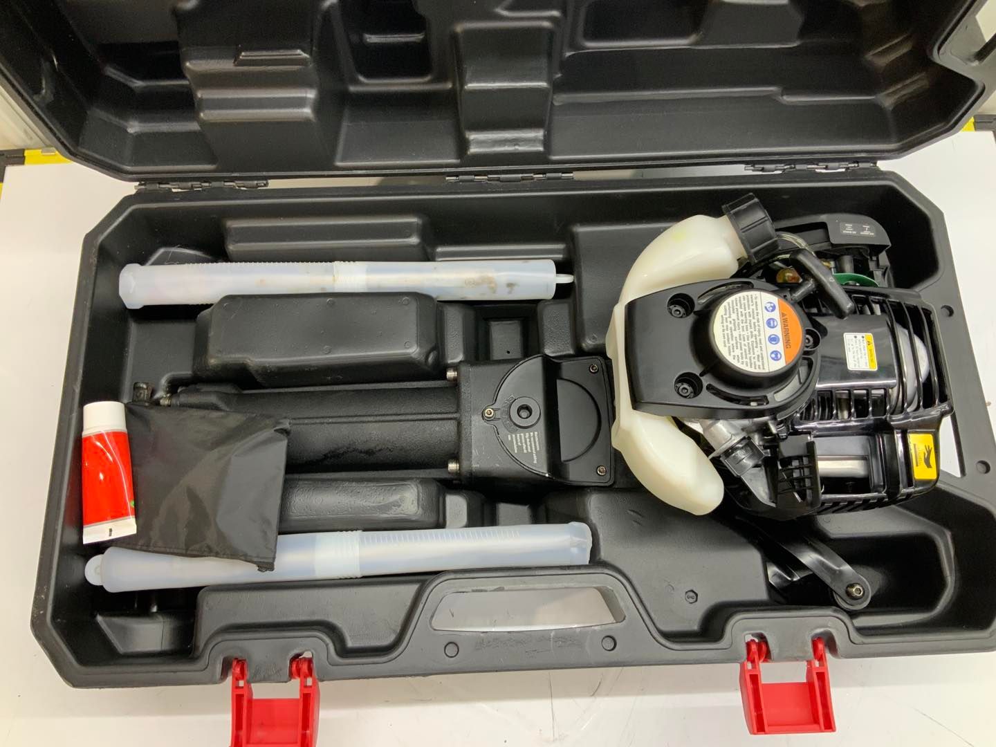 A black box filled with tools and a red handle