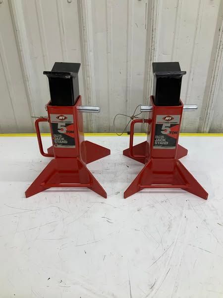 A pair of red jack stands sitting on top of a white table.