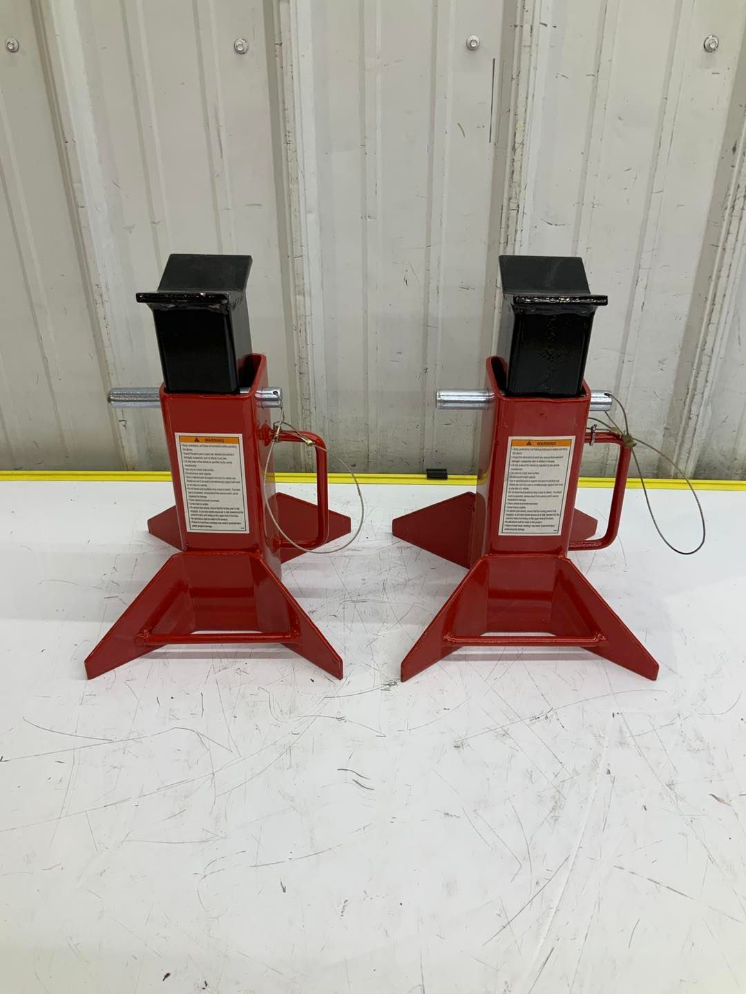 A pair of red jack stands sitting on top of a white table.