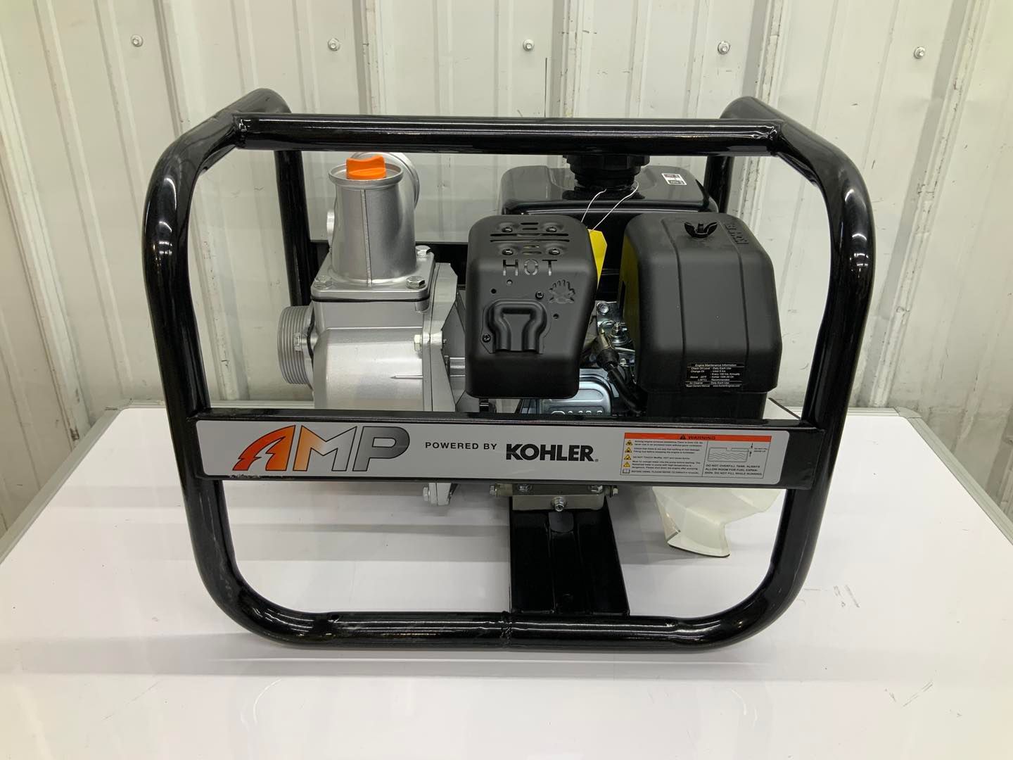 A kohler water pump is sitting on top of a white table.