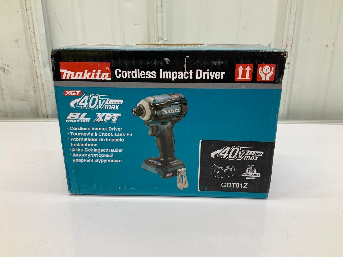 A makita cordless impact driver is in a box on a table.