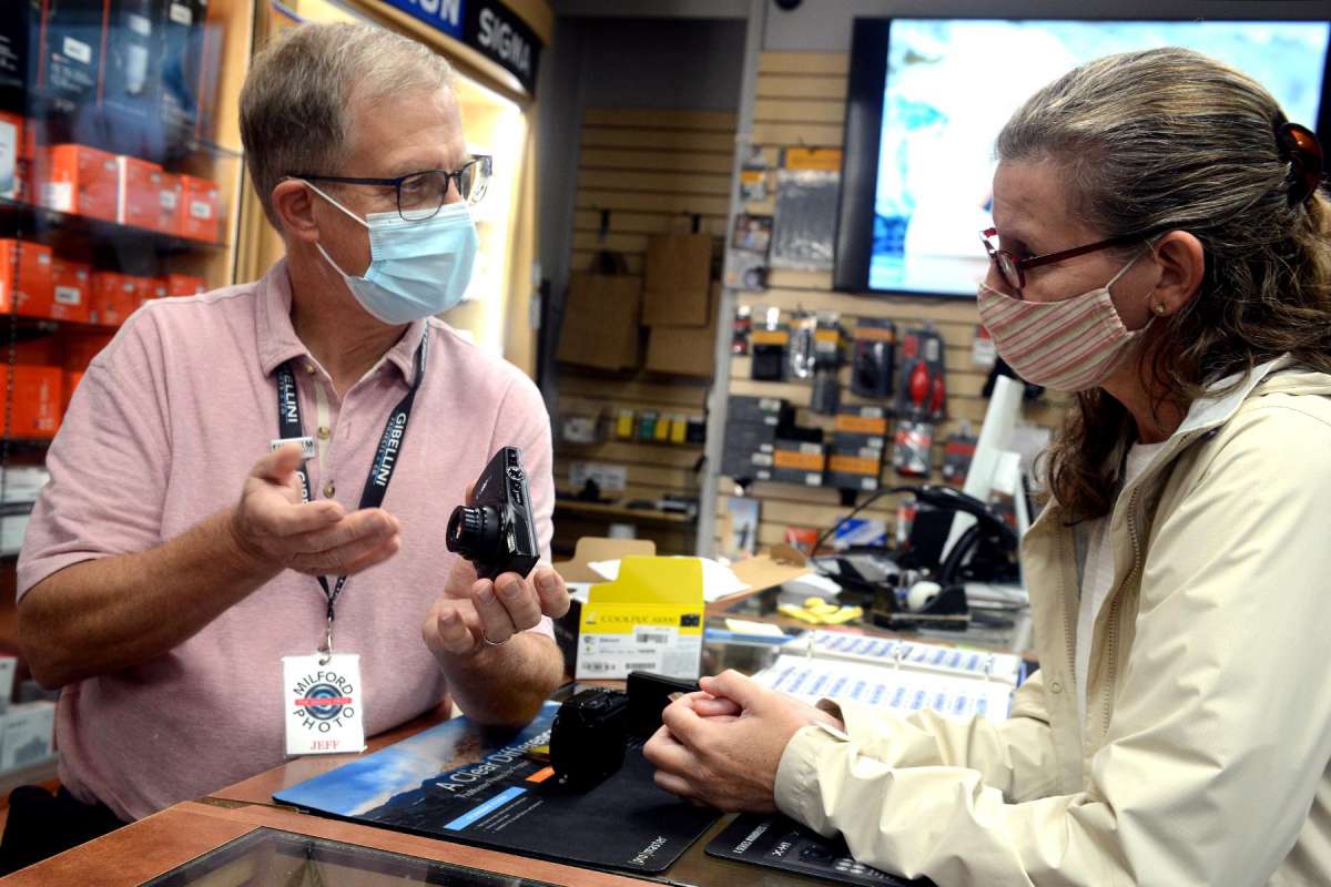Sales associate Jeff Scholl assists Dawn Tischbein, of Killingworth, as she shops for a digital camera at Milford Photo.