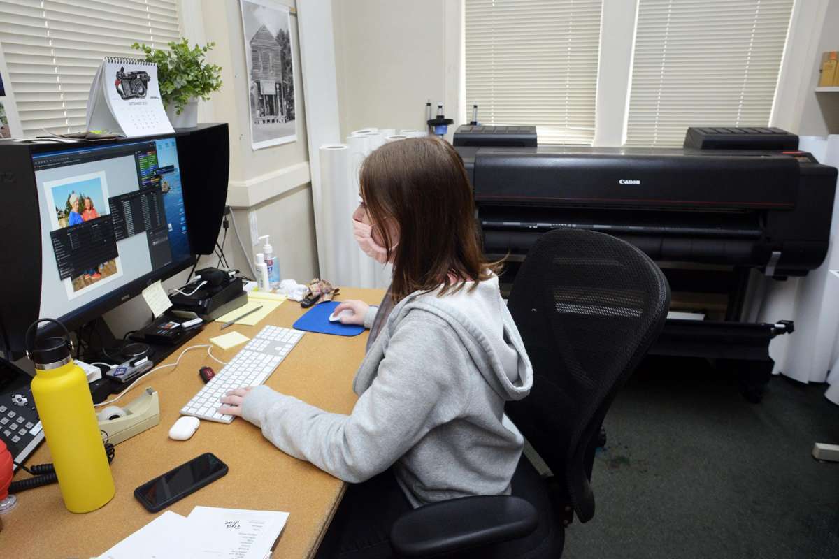 Digital lab technician Elisa Deely works on a photo restoration project at Milford Photo.