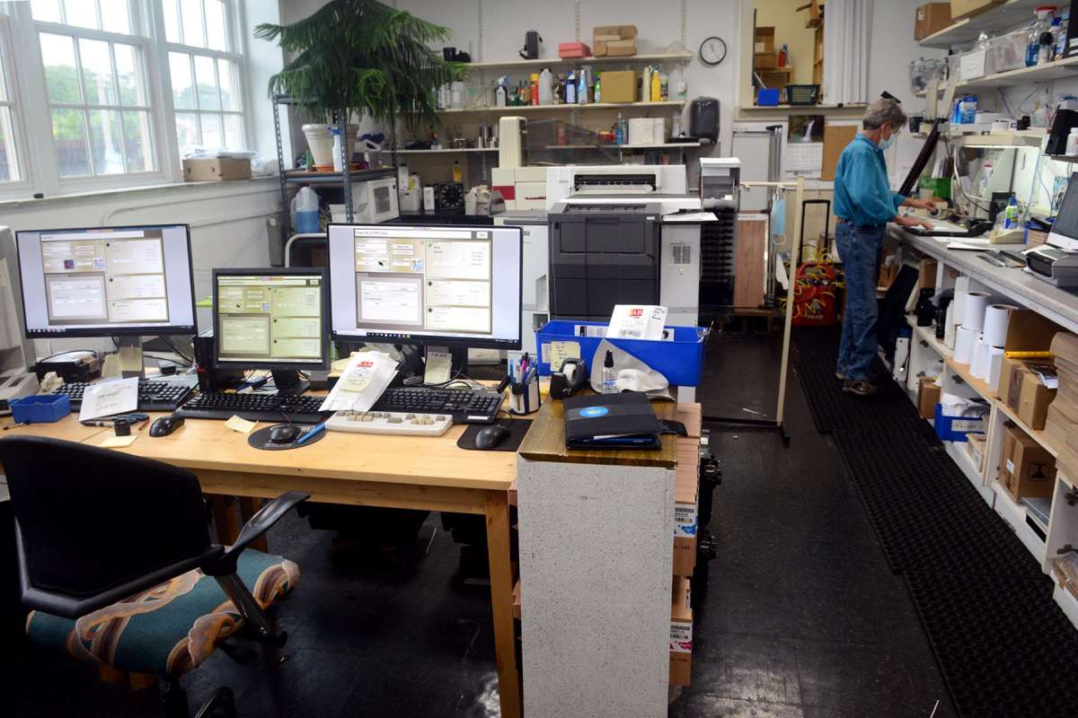 Photography lab technician Dory Neilson works in her modern photography darkroom at Milford Photo.