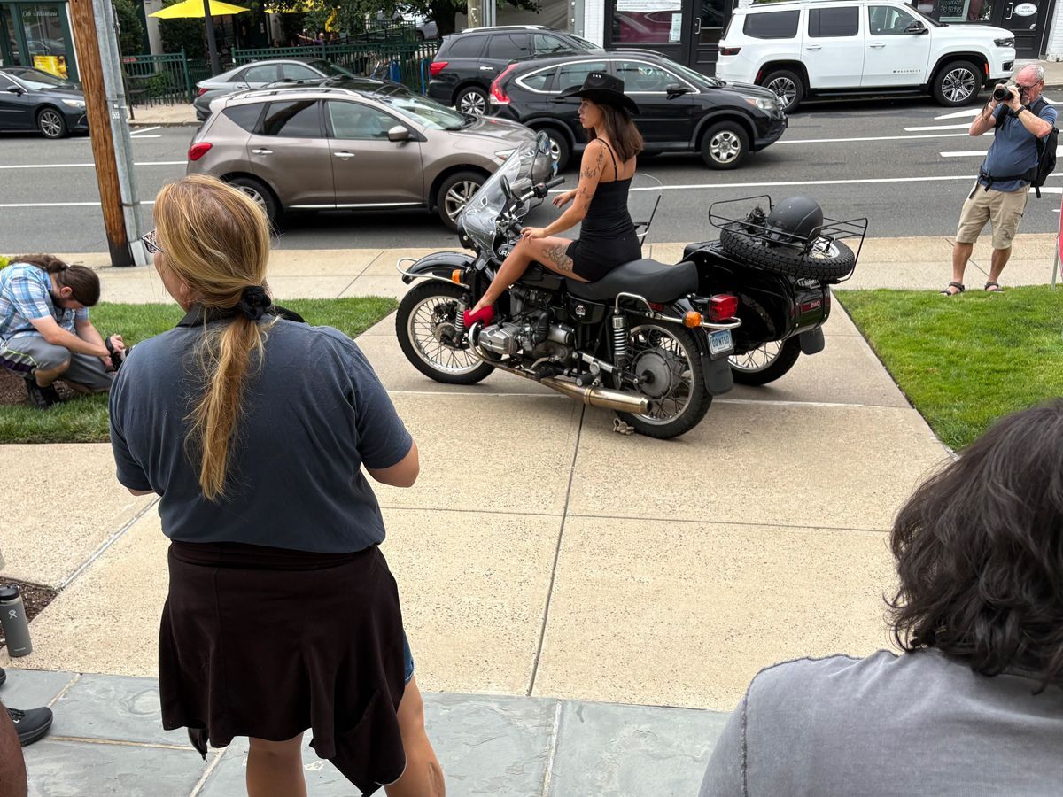 photographers enjoying photoshoot with model and motorcycle