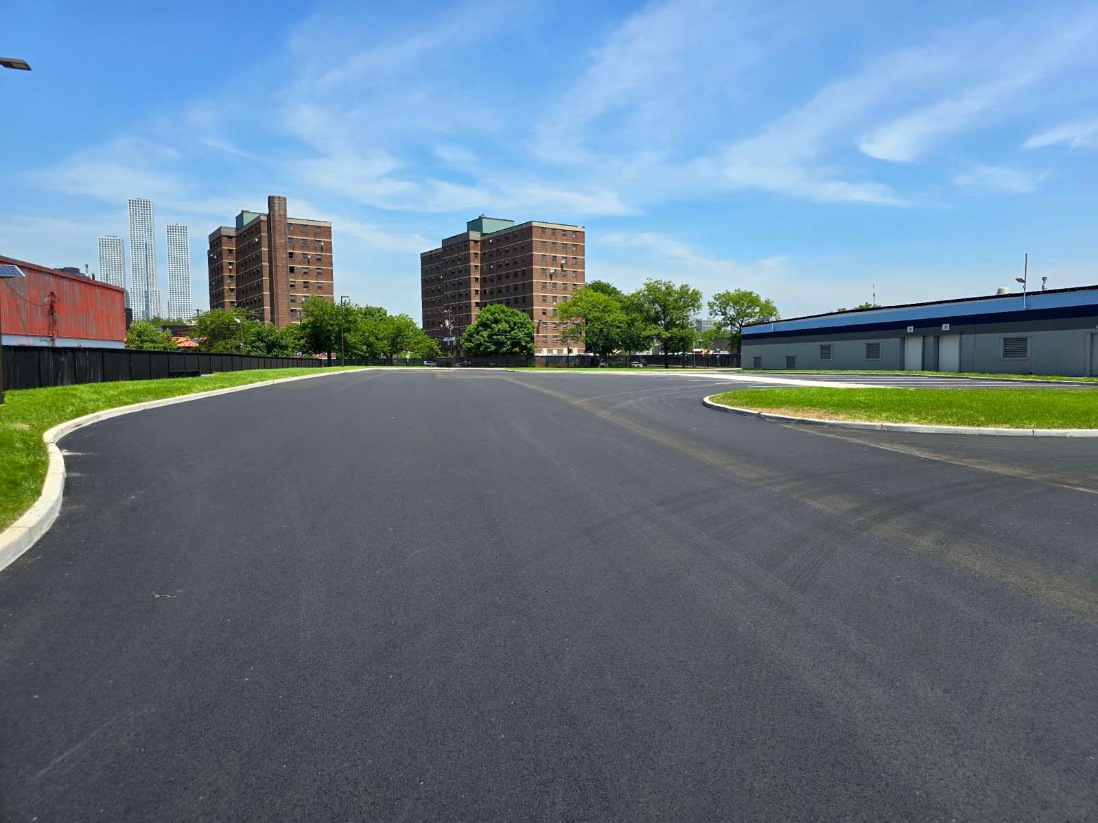 An empty road with buildings in the background on a sunny day