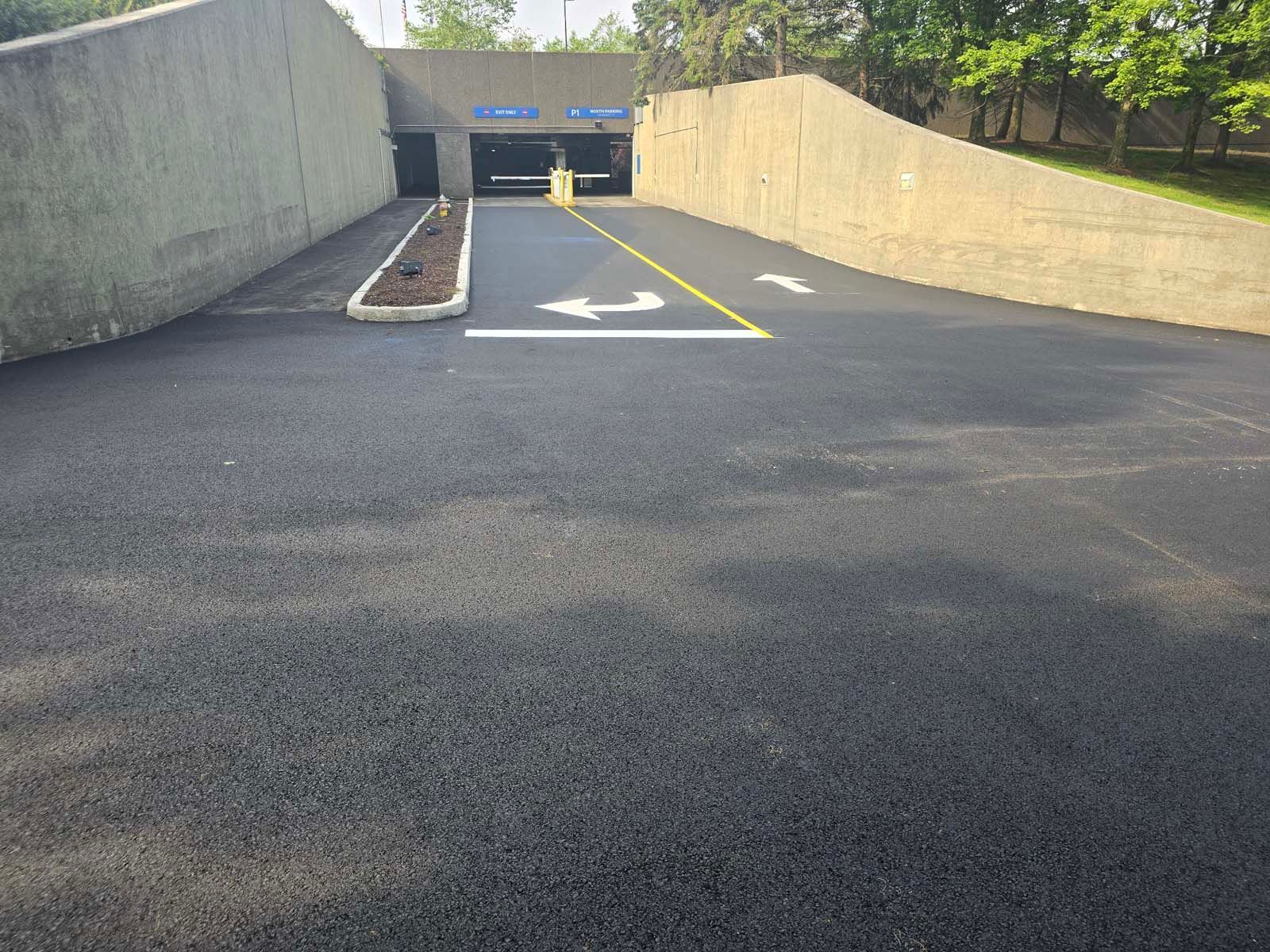 A parking lot with a ramp leading to a building.