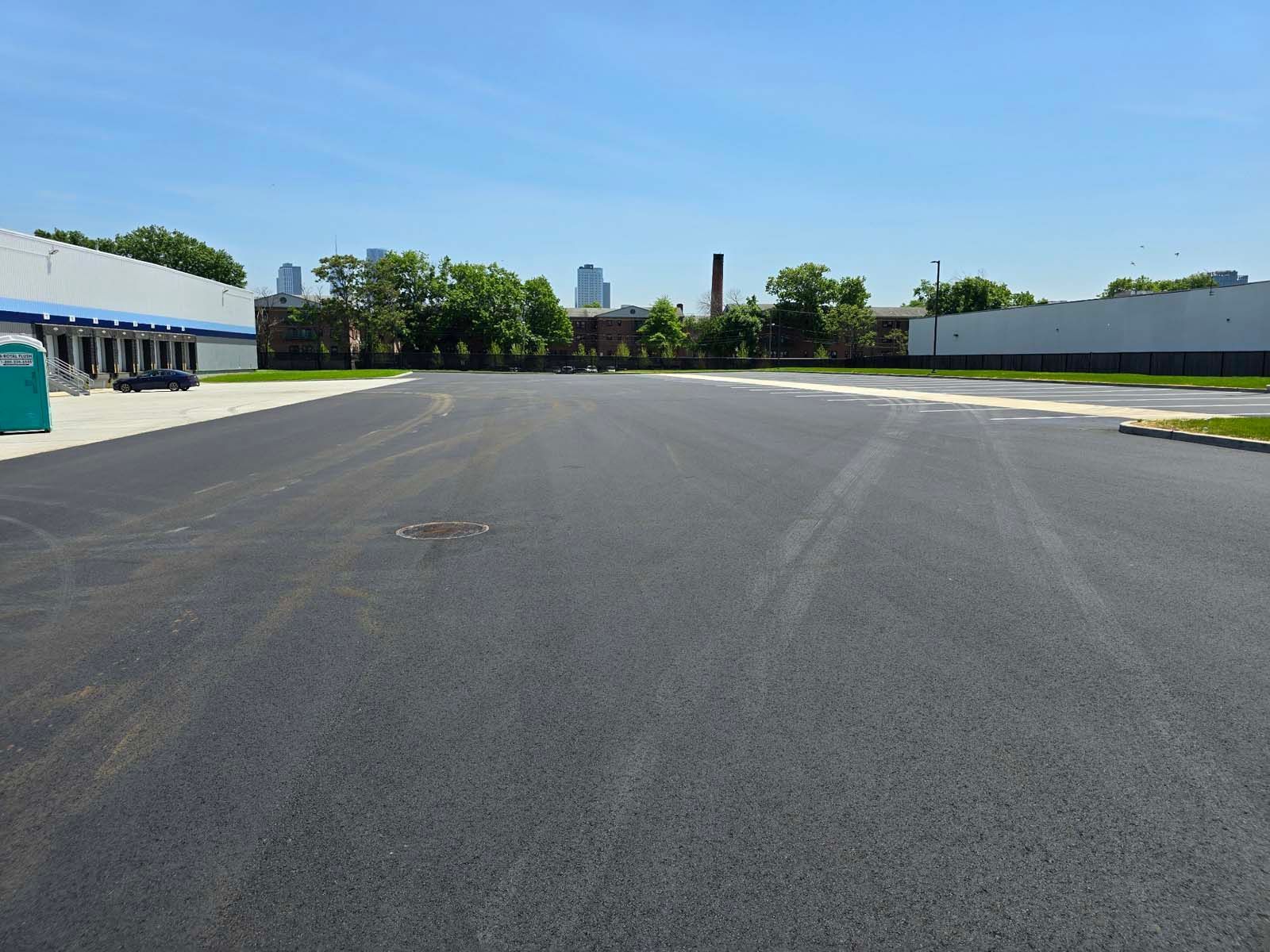 An empty parking lot with a building in the background