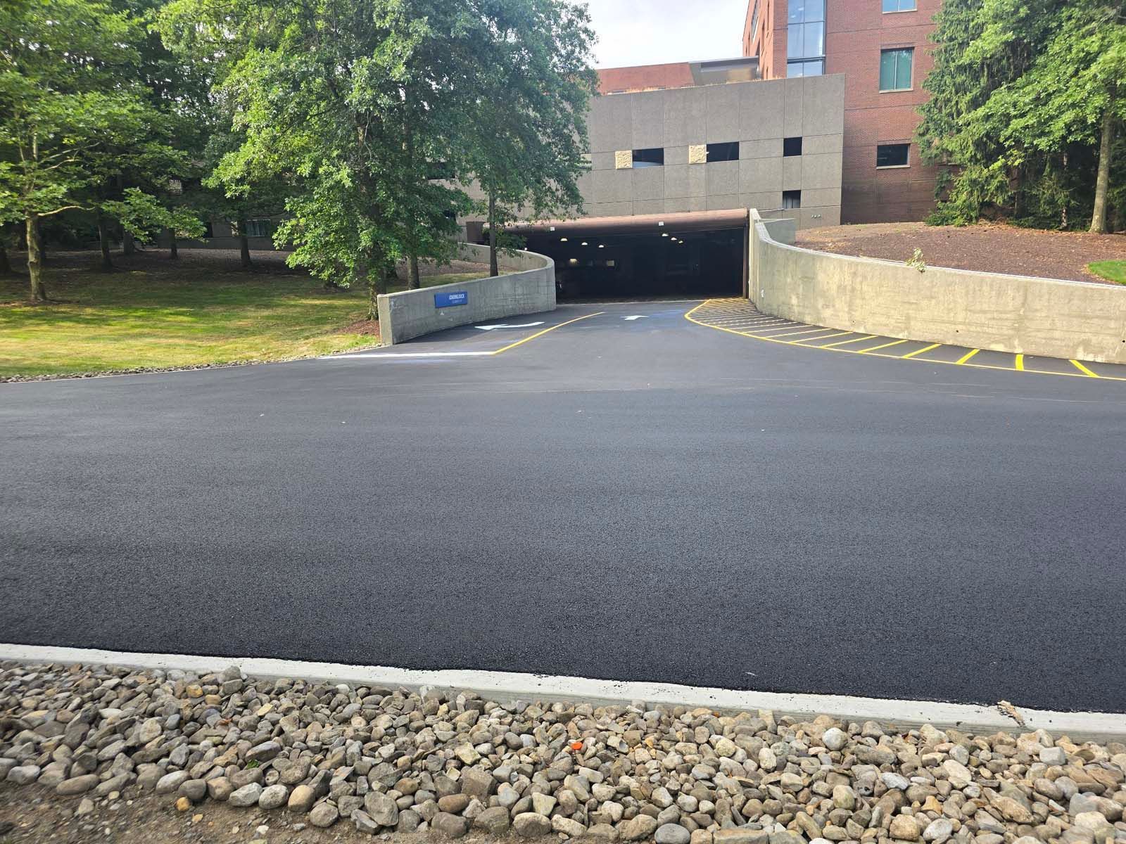 A road with a tunnel going through it and a building in the background