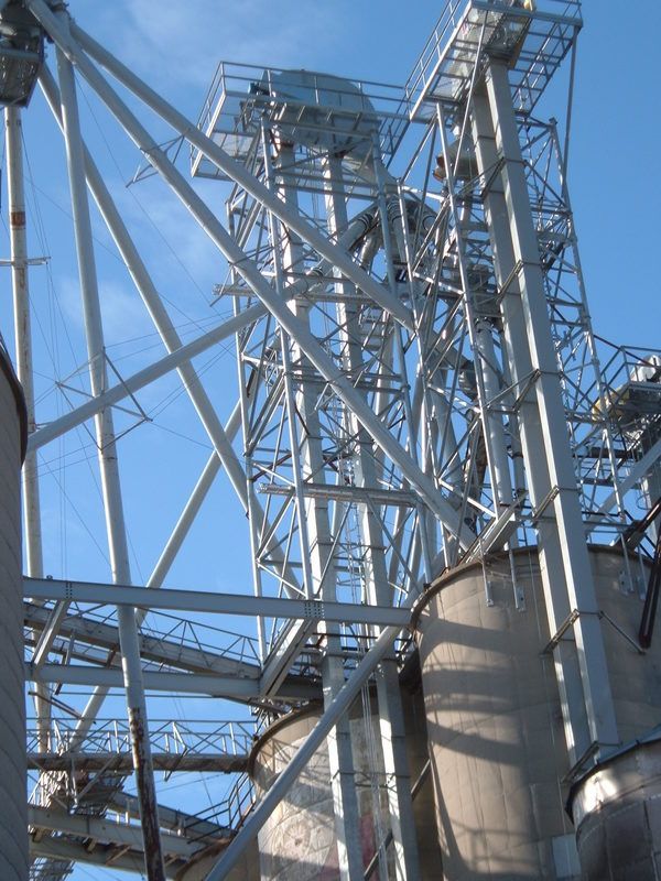 Industrial steel towers and pipes against a blue sky at a factory site