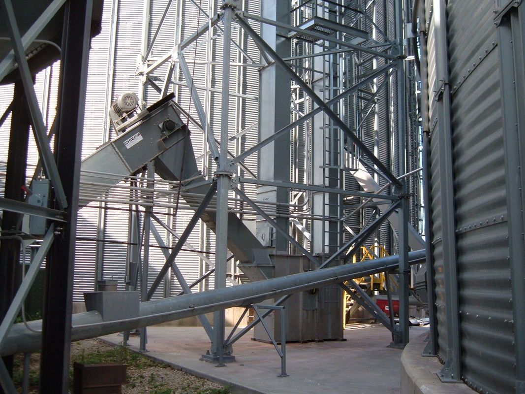 Industrial metal framework with stairways and beams inside a silo or factory structure