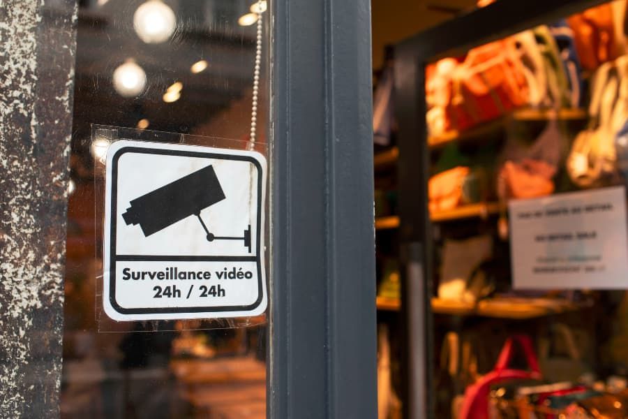 24-hour surveillance sign in shop window 