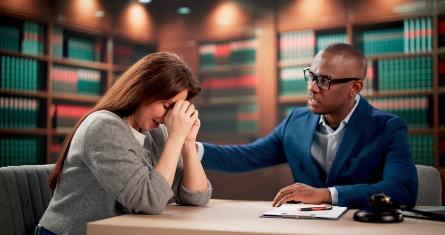 A lawyer comforting a crying personal injury client.