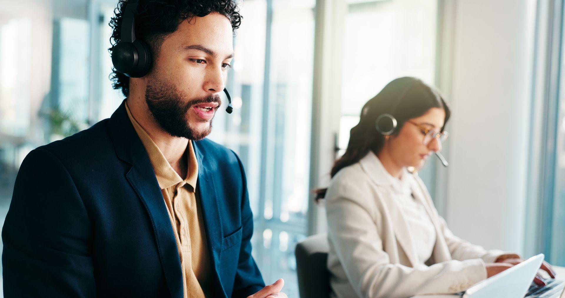 Consultant working at a computer to discuss debt collection, loans, and related questions.