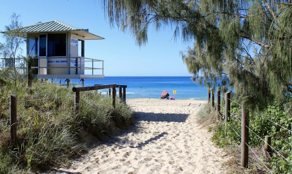 A Path Leading to A Beach with A Lifeguard Tower in The Background — Webster Rock Walls In Maroochydore, QLD