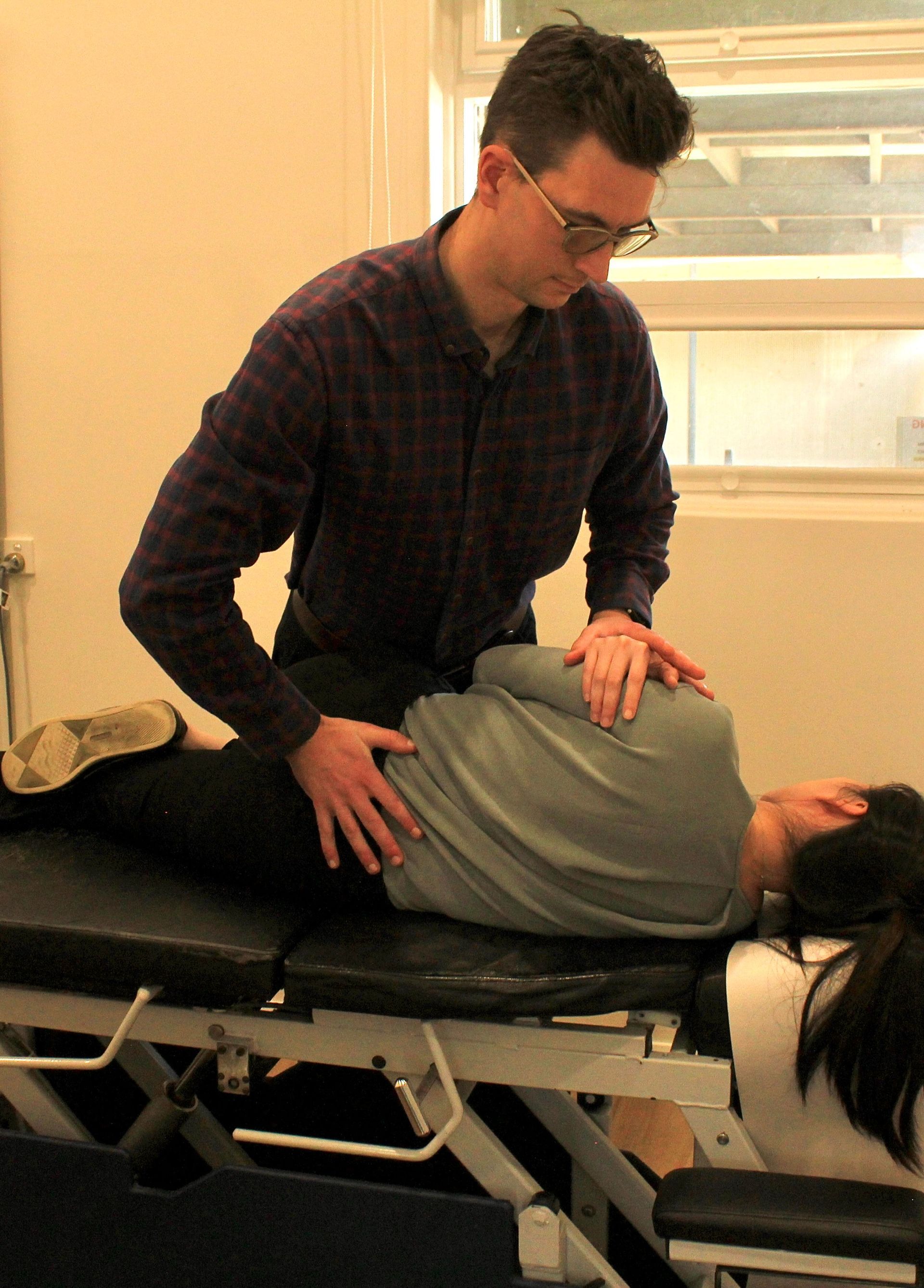 Chiropractor performing treatment for sciatic nerve pain