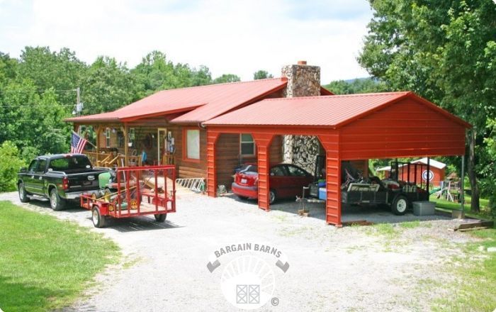 A house with a red roof and a carport