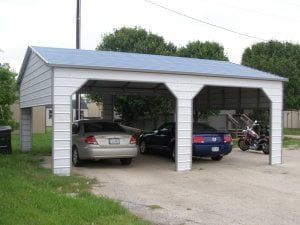 Two cars are parked under a carport with a blue roof.