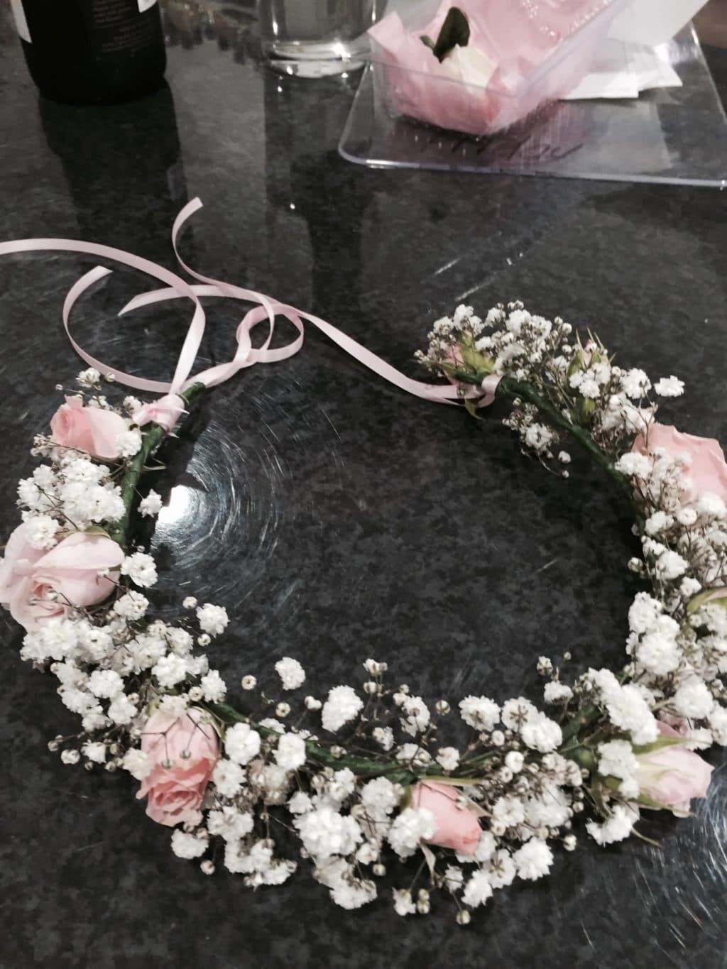 A Flower Crown With Pink Roses and Baby 's Breath is on a Table — Bundaberg House of Flowers in Bundaberg West, QLD