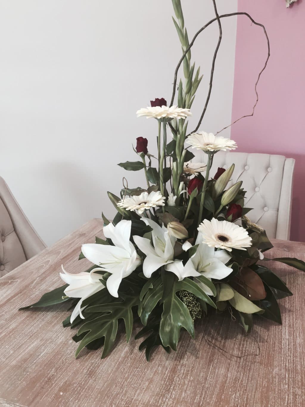 A Bouquet of Flowers Is Sitting on A Wooden Table — Bundaberg House of Flowers in Bundaberg West QLD