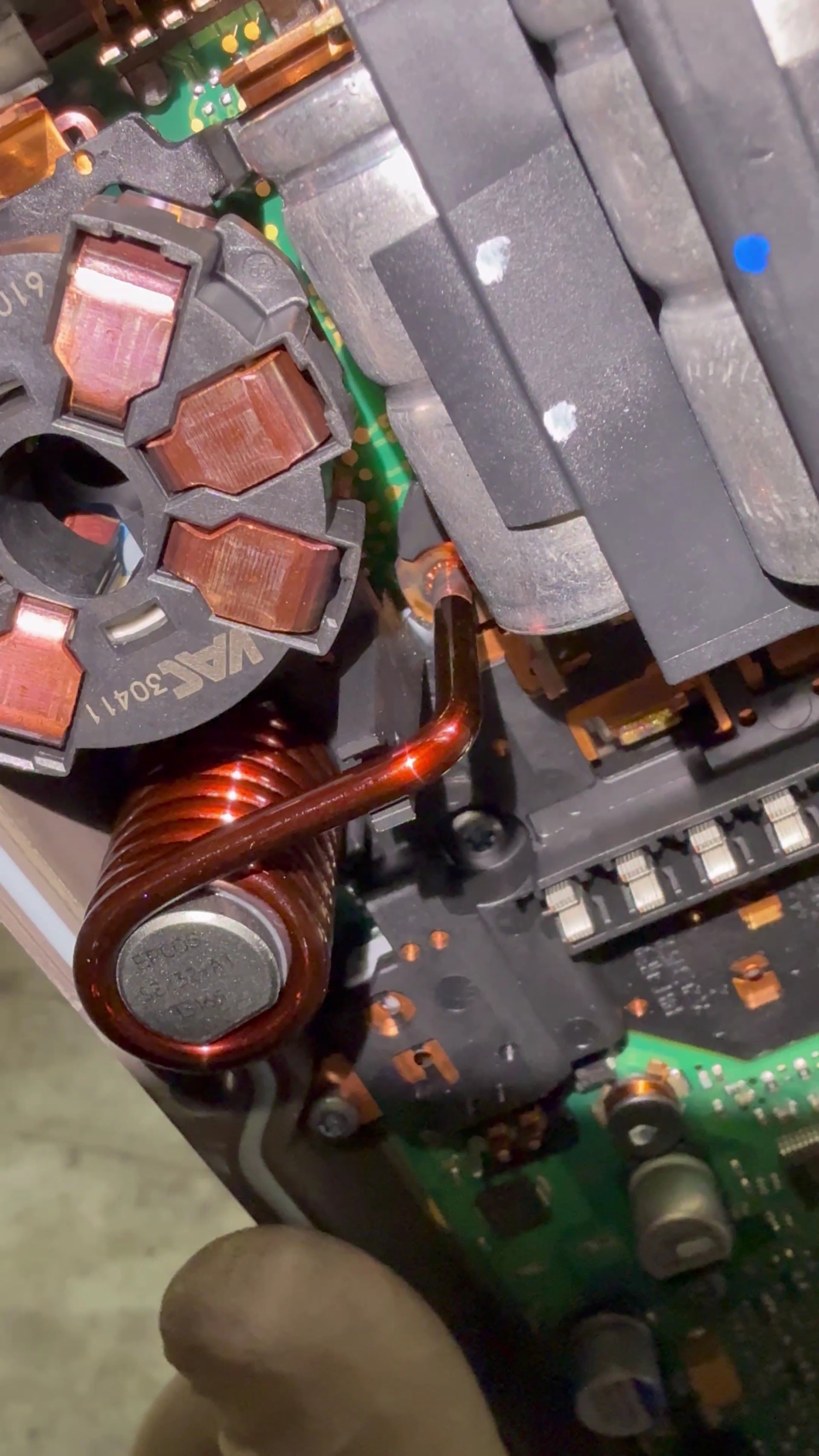 Close-up of a computer motherboard with copper coils, gray heat sink fins, and electronic components | Lapin Auto Repair