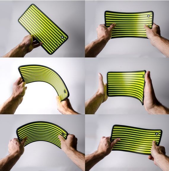 Hands flexing a flexible, black-bordered, striped, lime-green rectangle against a white background.