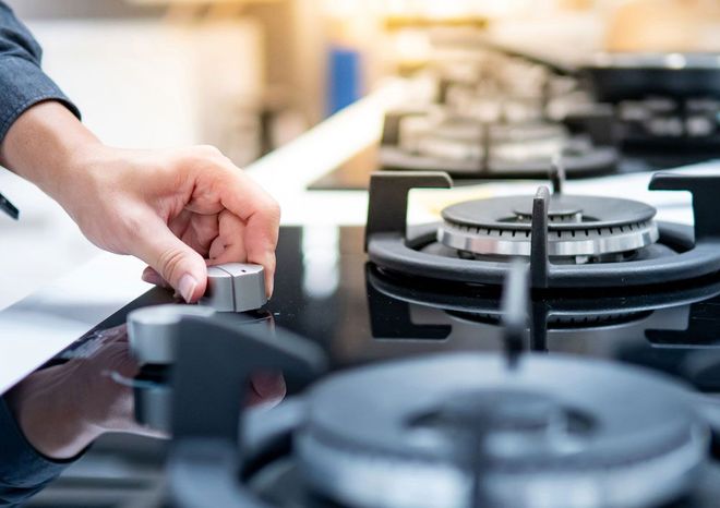 Turning Switch Knob On Gas Stove — Corona, CA — Tru-Way Appliance Parts & Service