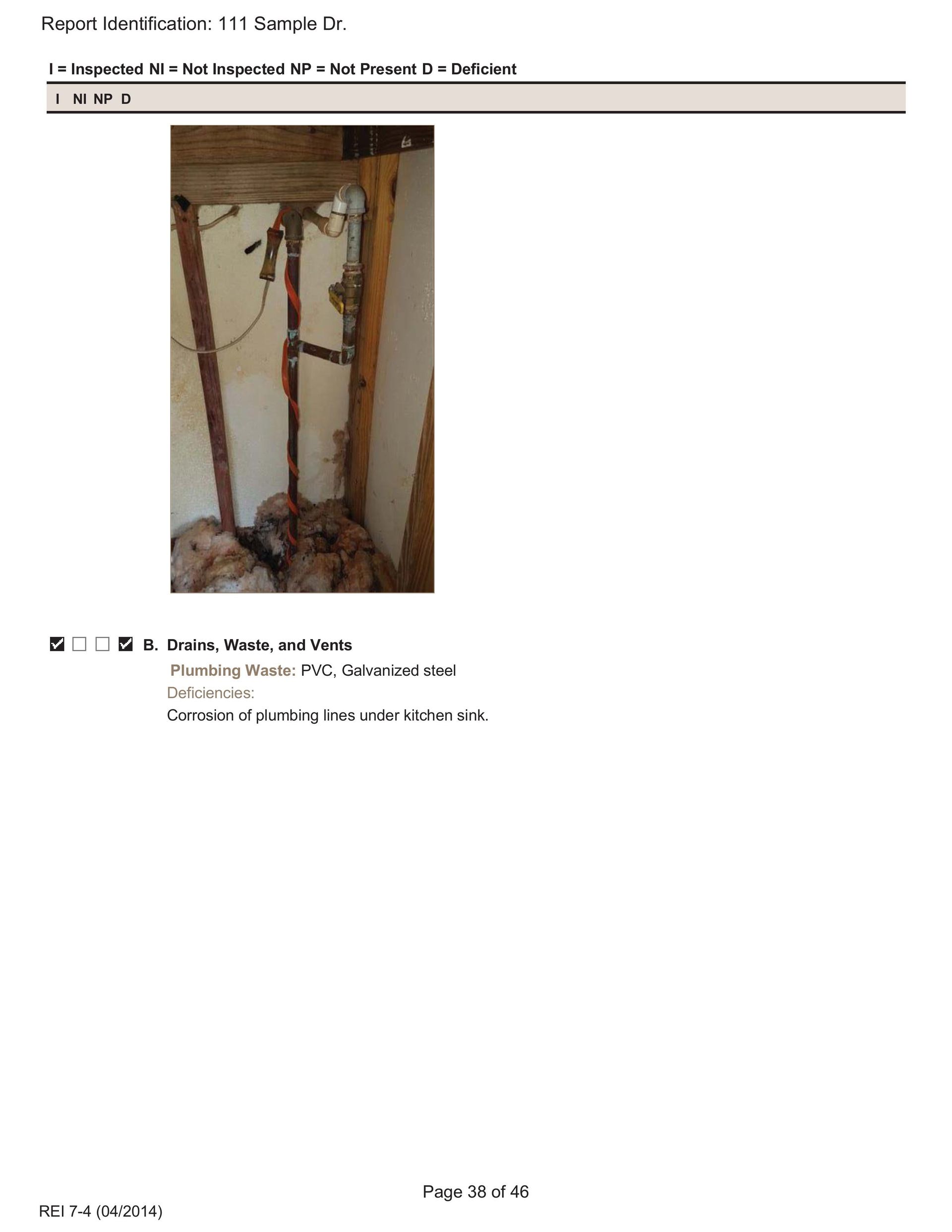 Plumbing pipes exposed within a wall cavity, with visible wood framing and insulation at the bottom.