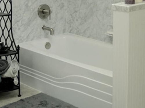 a bathroom with a bathtub and a shelf with towels on it .