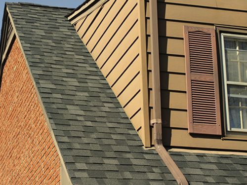 a house with a roof and a window with shutters