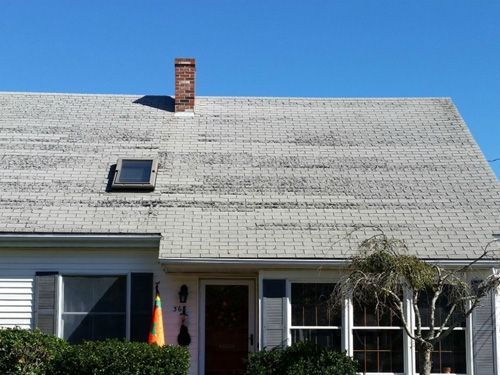 a white house with a chimney on the roof