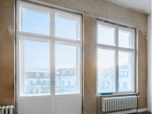 a room with a lot of windows and a radiator .