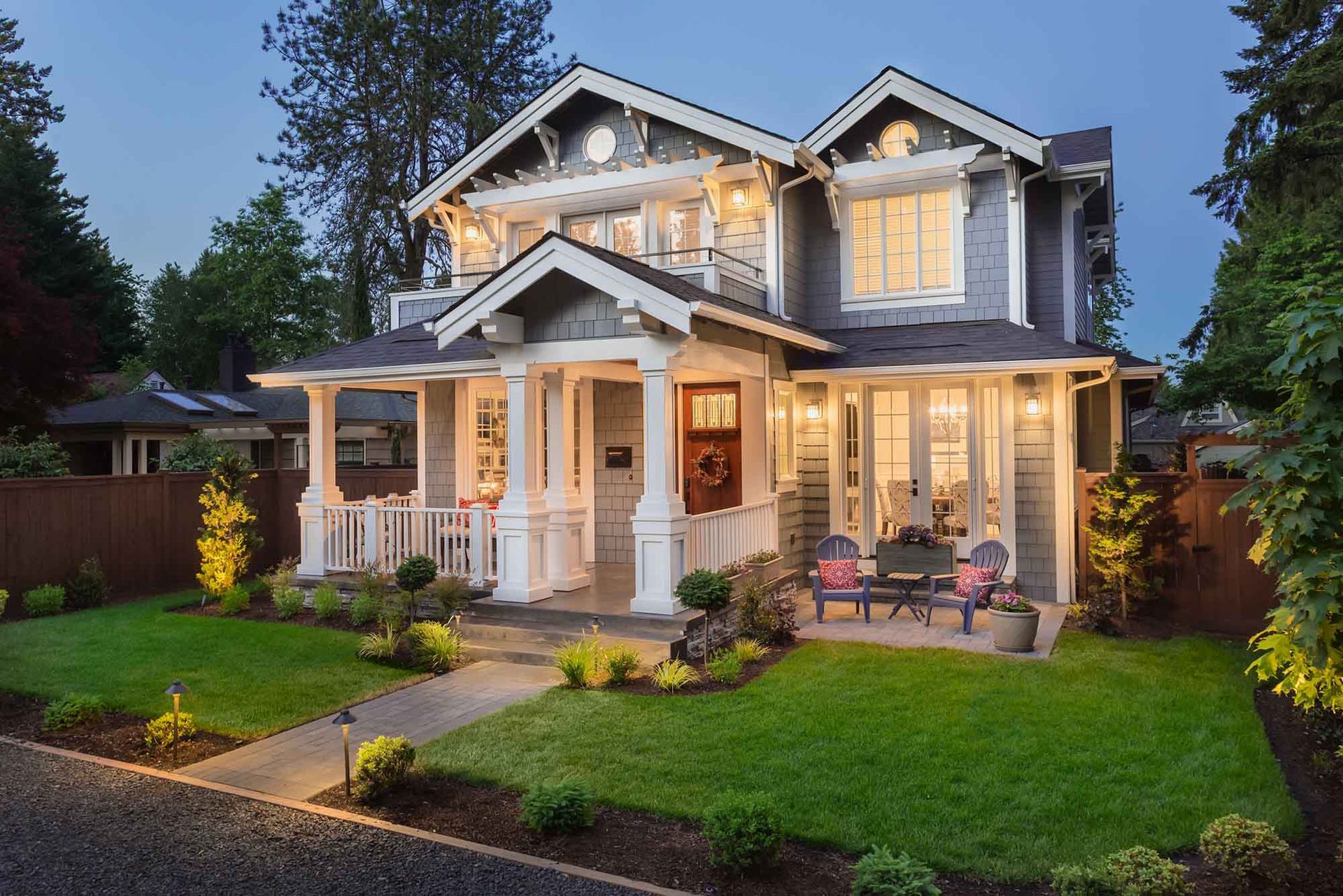 a large house with a large porch is lit up at night .