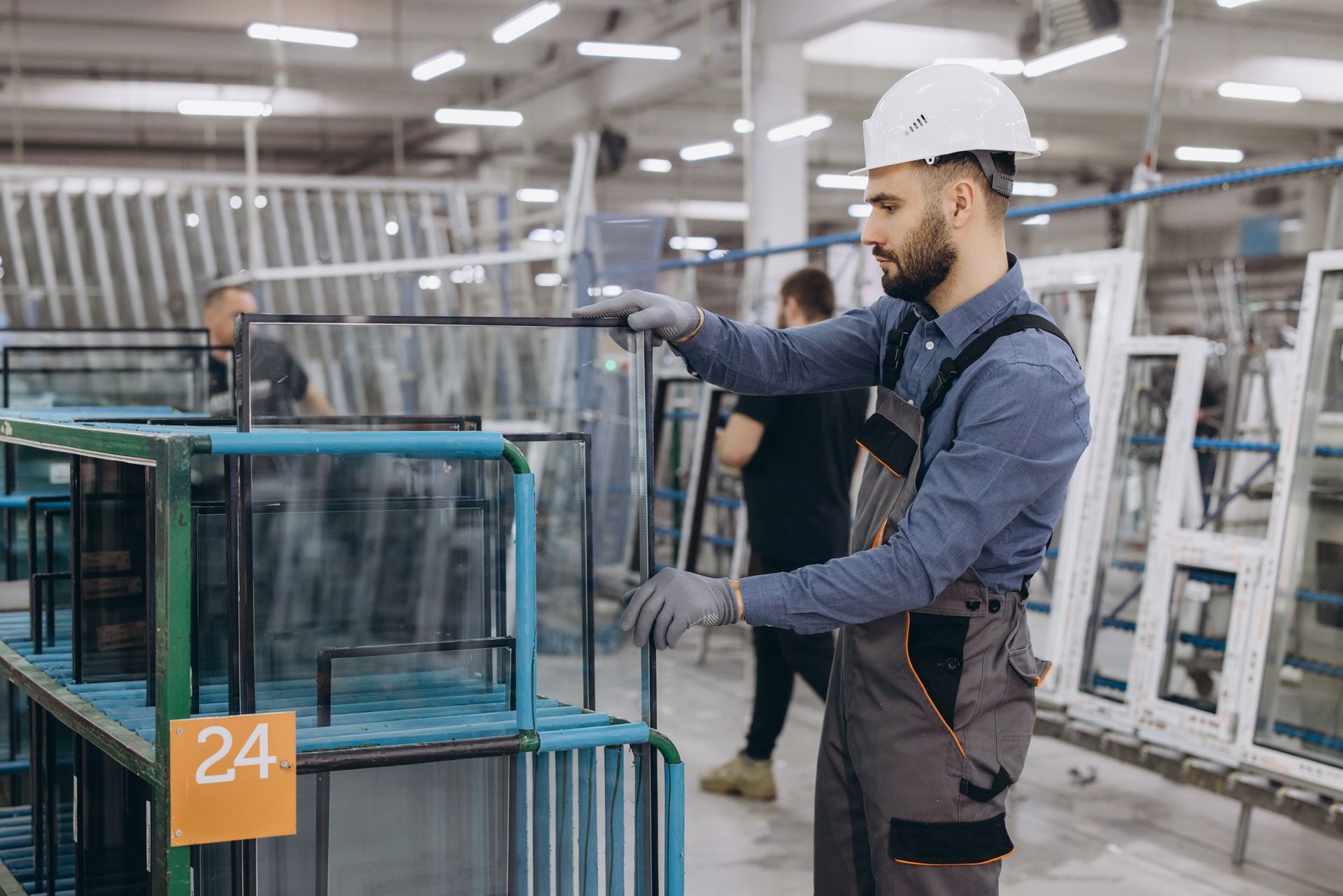 worker stacking windows in warehouse ready to ship