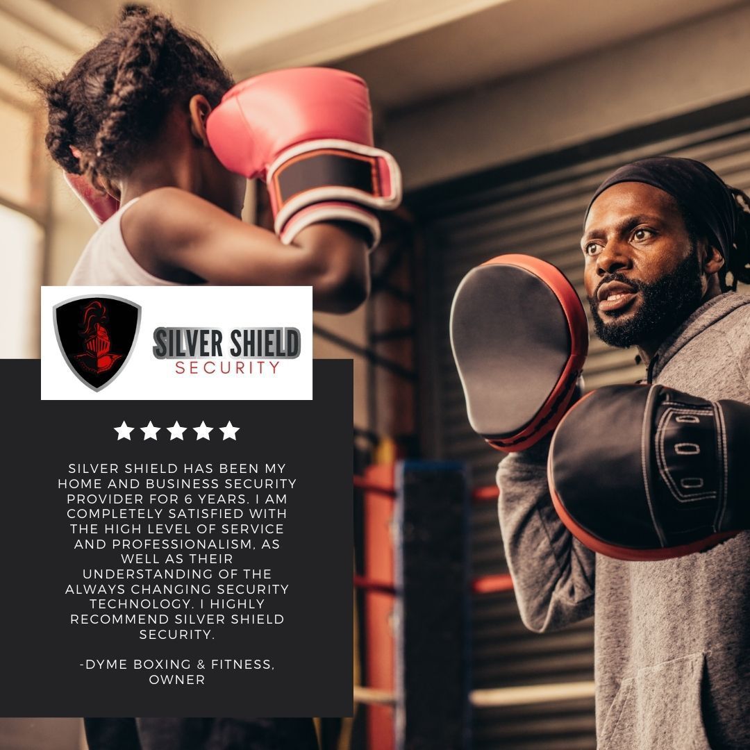 Silver Shield Security ad with a boxer in red gloves and a man holding focus pads in a gym
