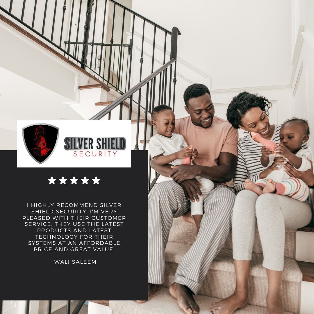 Family relaxing on a sofa beside a Silver Shield Security ad poster