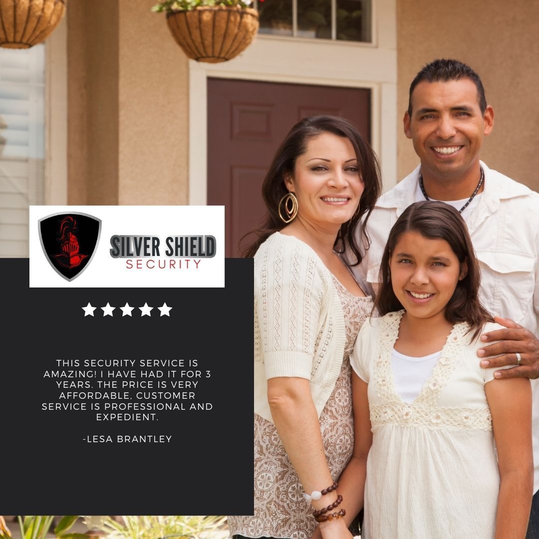 Family standing outside home beside Silver Shield Security ad sign