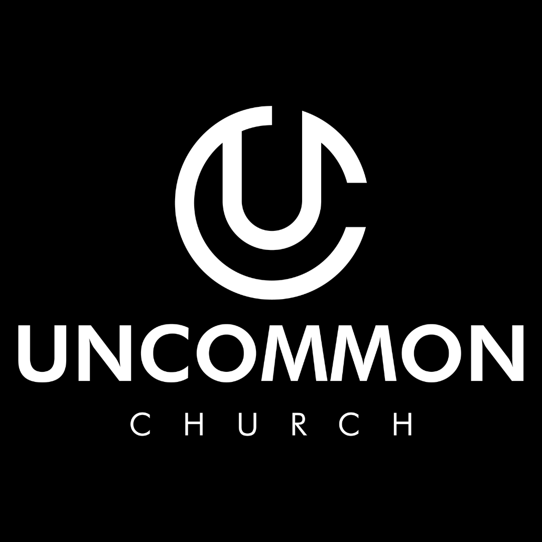 White Uncommon Church logo and wordmark on a black background