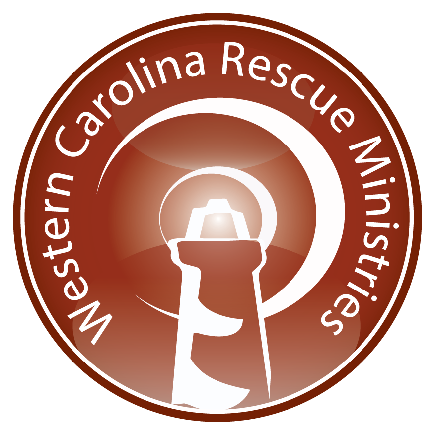 Western Carolina Rescue Ministries logo in brown and white with a lighthouse silhouette and circular text