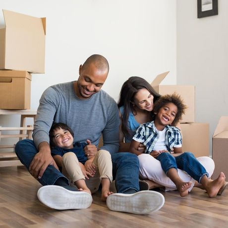 Happy Family Sitting On Floor