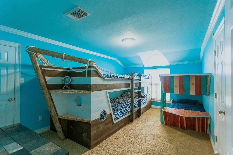 A bedroom with bunk beds in the shape of a boat.