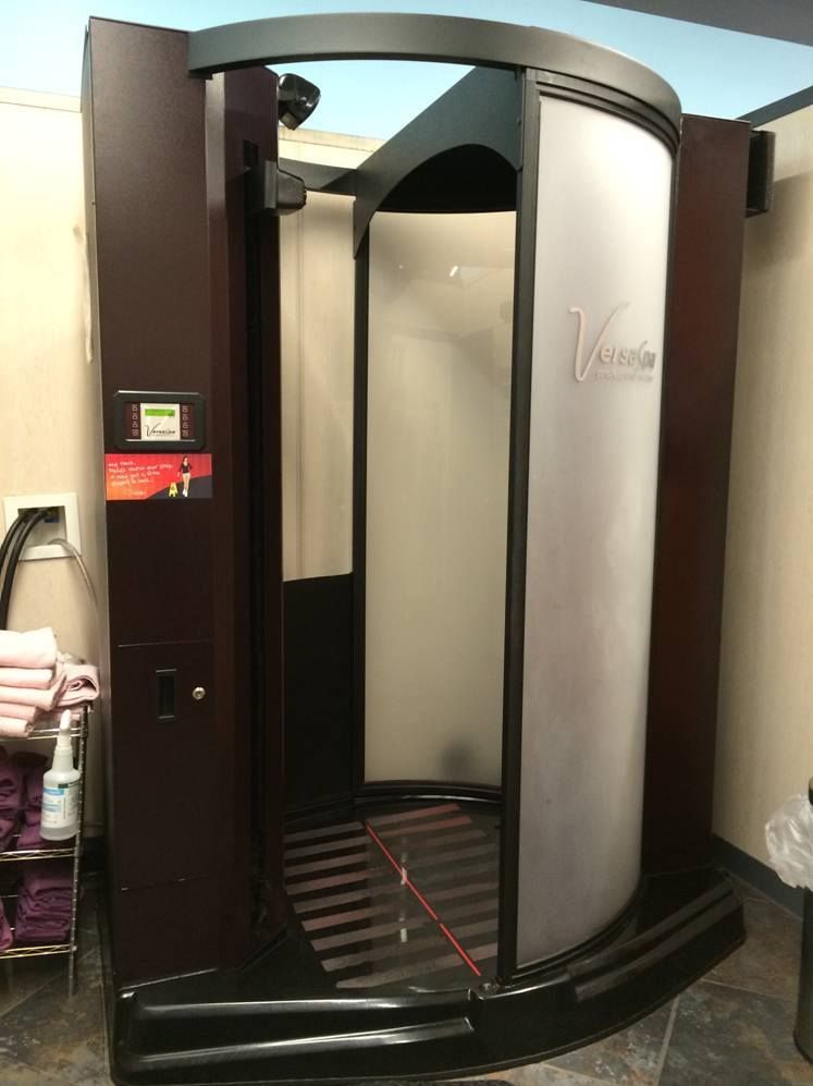 A Tanning Booth is Sitting in a Room Next to a Trash Can — Erikka's All Occasion Beauty In Rockhampton City, QLD