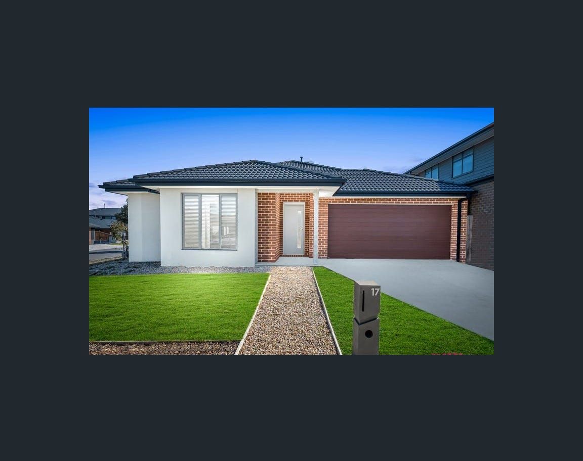 Modern single-story house with a lawn, stone path, and a brown garage door.