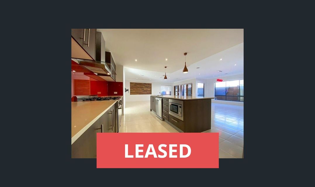 A modern kitchen with a large island. A red "LEASED" banner is across the bottom.