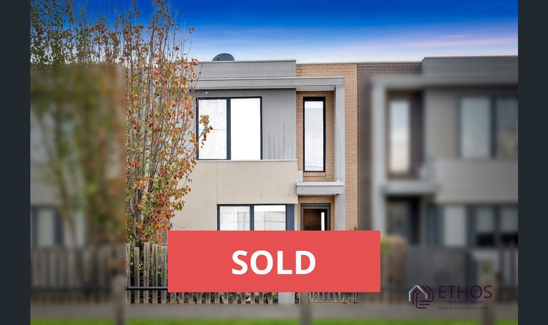 Modern two-story house with "SOLD" overlay; the exterior is beige, blue sky, and tree in front.