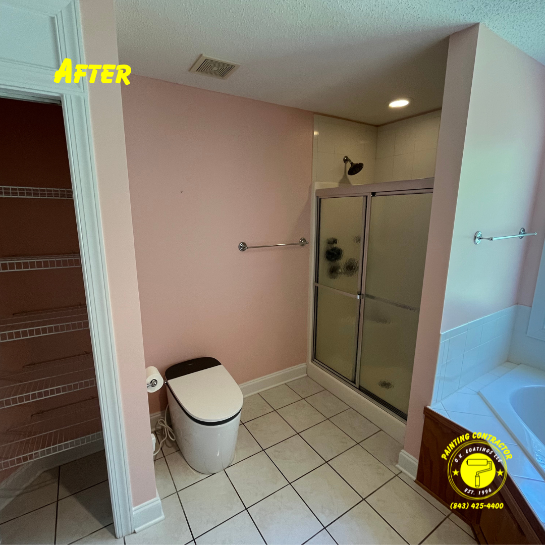 A renovated bathroom featuring blush pink walls, a modern white toilet, tiled floors, a walk-in shower, and a bathtub.