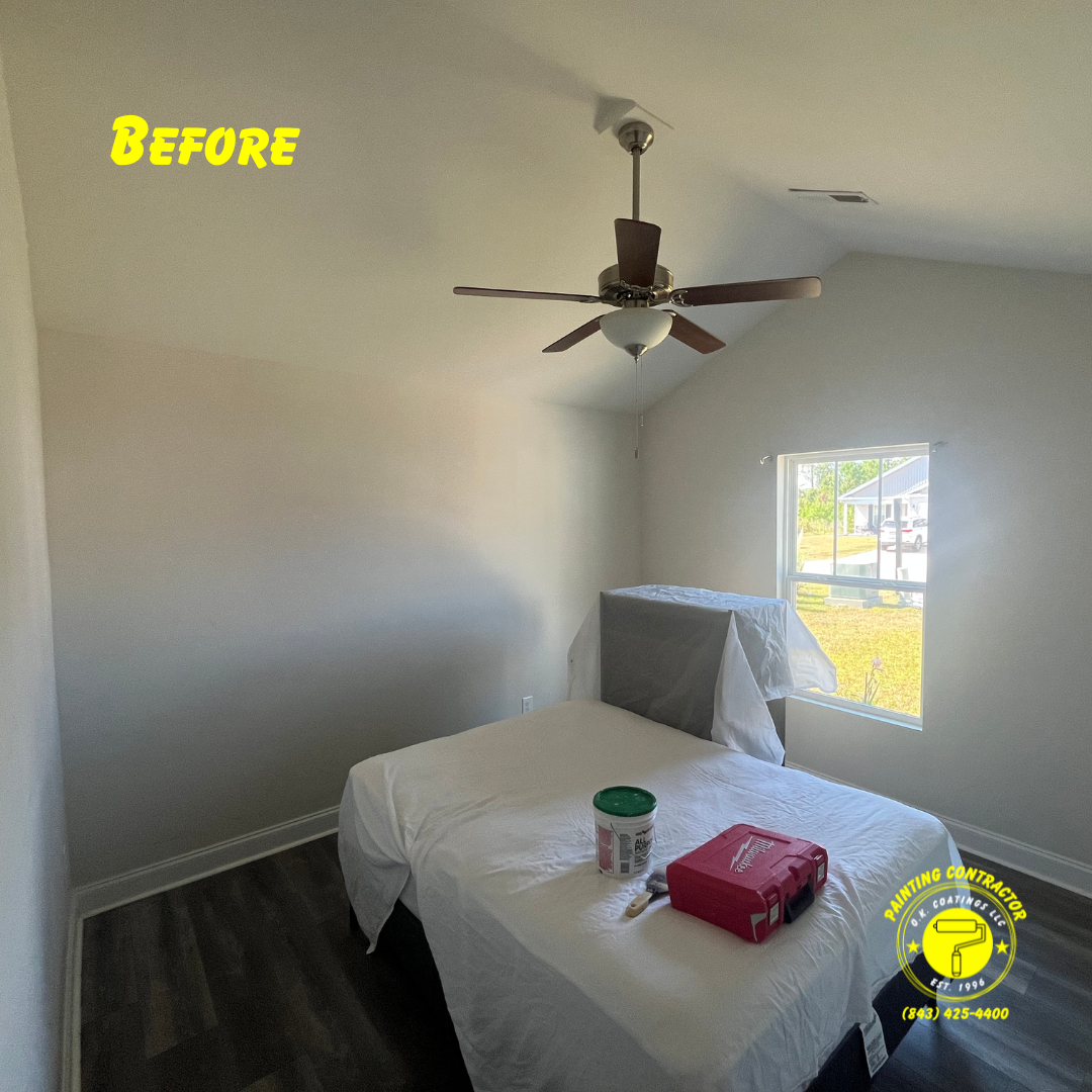 A bedroom during home renovation, featuring a bed covered in a drop cloth, a paint bucket, and tools, with 